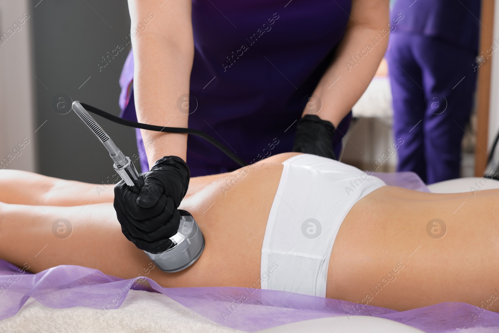 Photo of Woman undergoing radio frequency lifting procedure in beauty salon, closeup