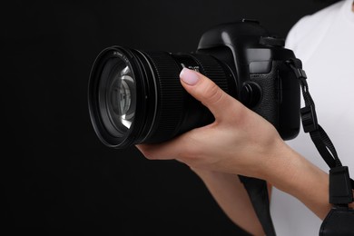 Photo of Photographer with camera on black background, closeup