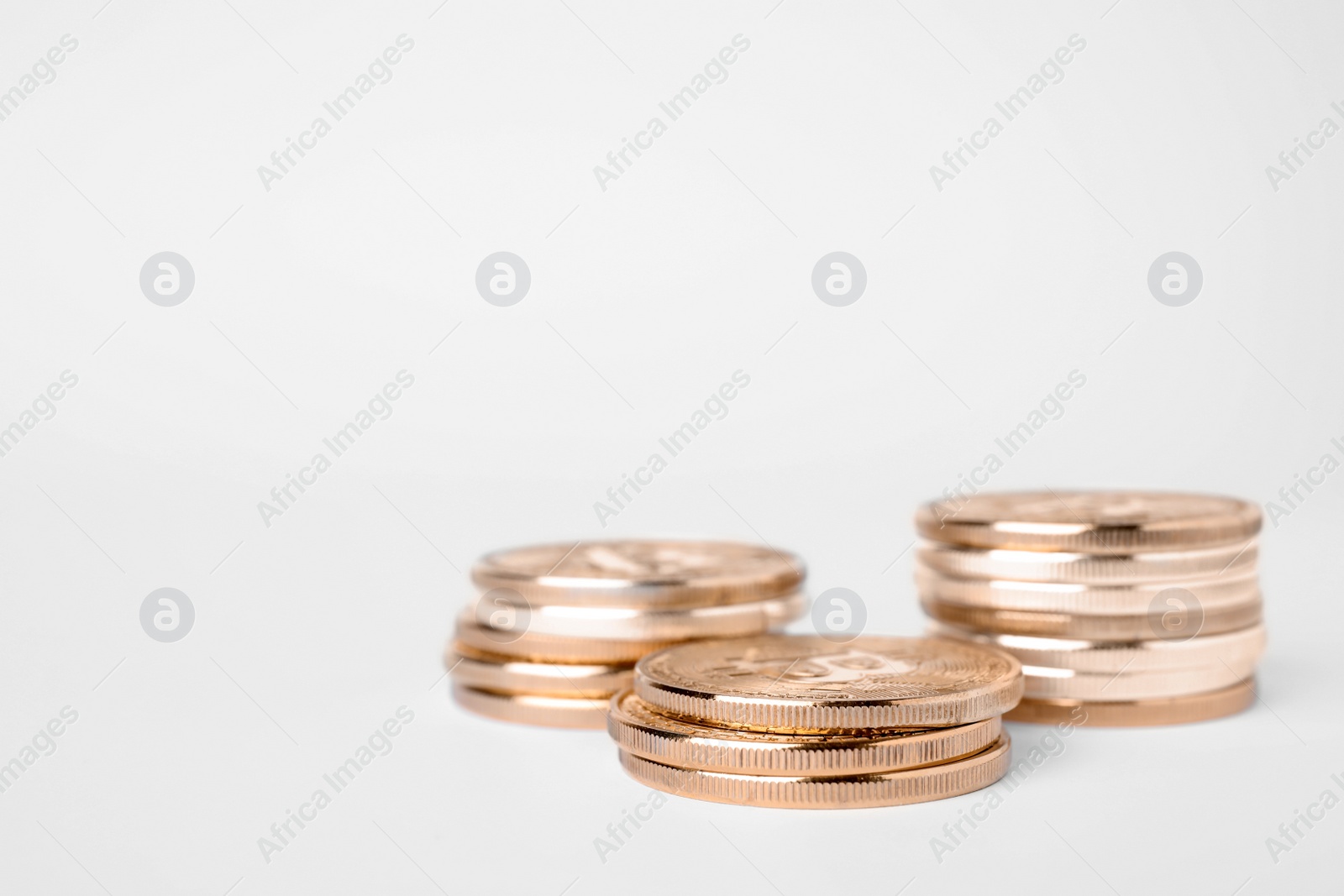 Photo of Golden bitcoins on white background. Digital currency