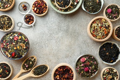 Photo of Frame of different herbal teas on grey table, flat lay. Space for text