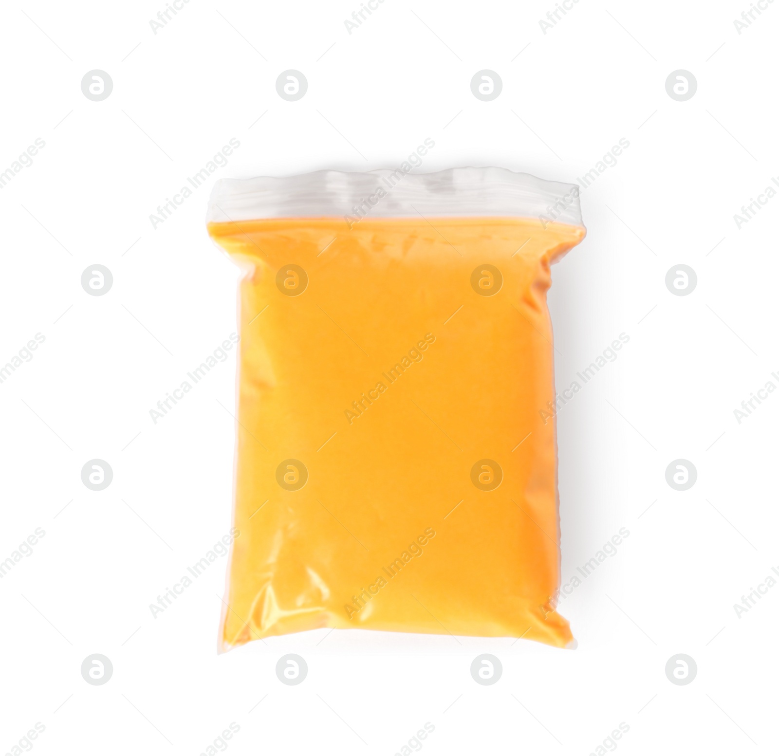 Photo of Package of orange play dough isolated on white, top view