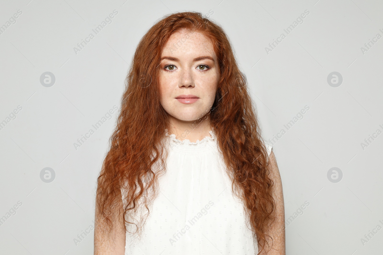 Photo of Portrait of young woman with beautiful face on grey background