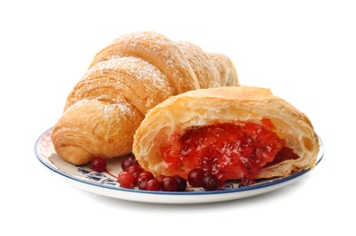 Tasty croissants with jam on plate against white background