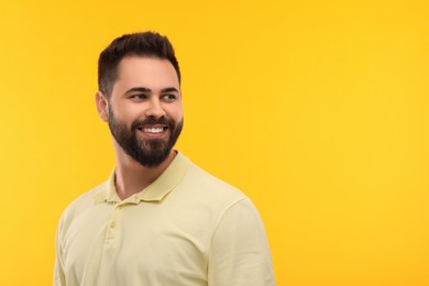 Photo of Man with clean teeth smiling on yellow background, space for text