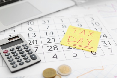 Photo of Composition with calendar and calculator on table. Tax day