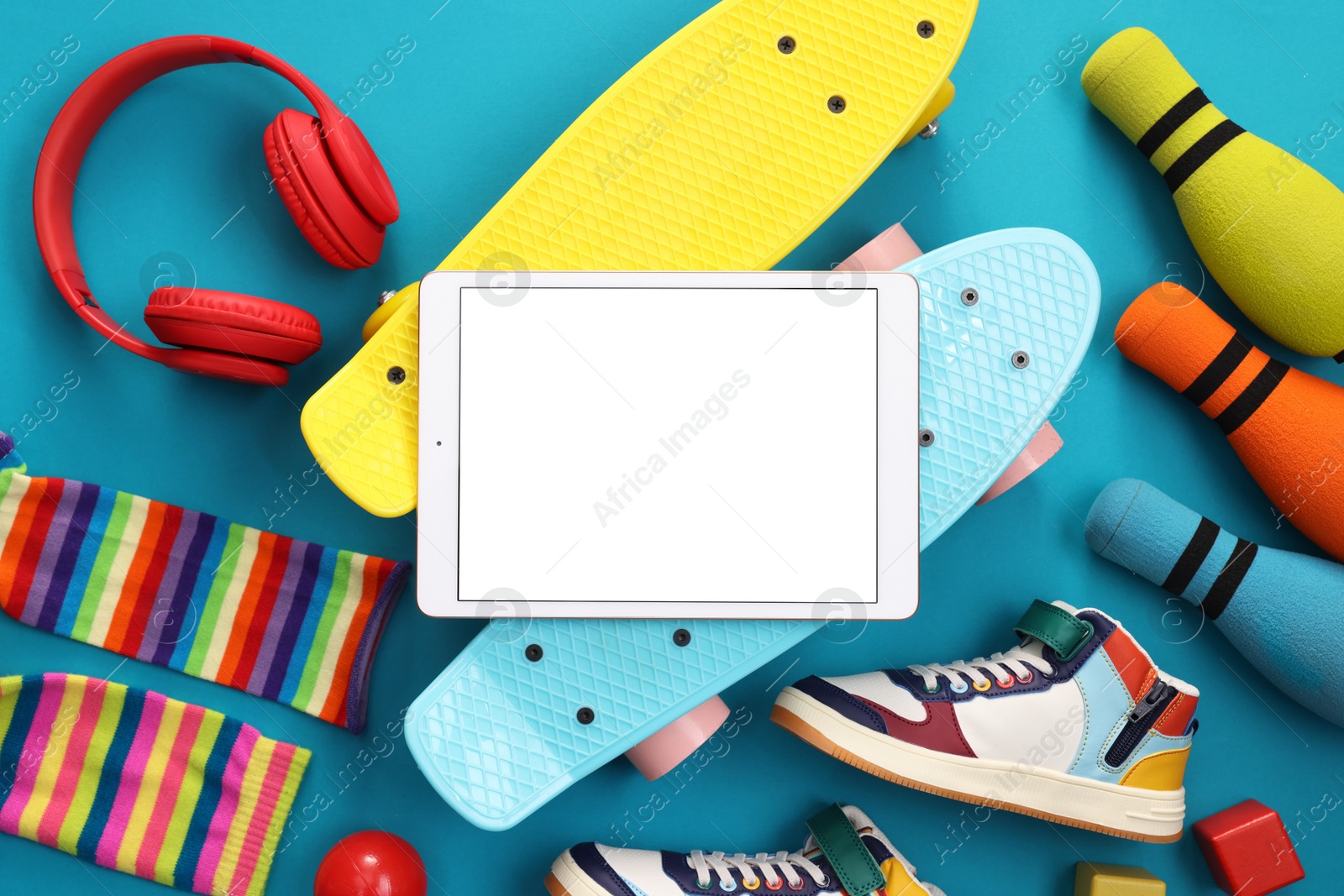 Photo of Flat lay composition with modern tablet on light blue background. Space for text