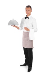 Waiter holding metal tray with lid on white background