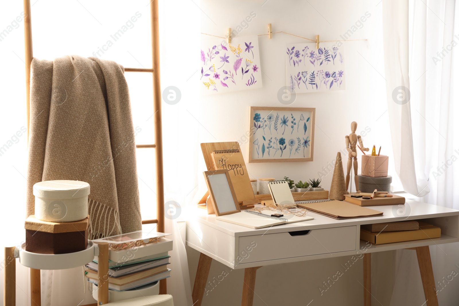 Photo of Stylish room interior with creative workplace near white wall