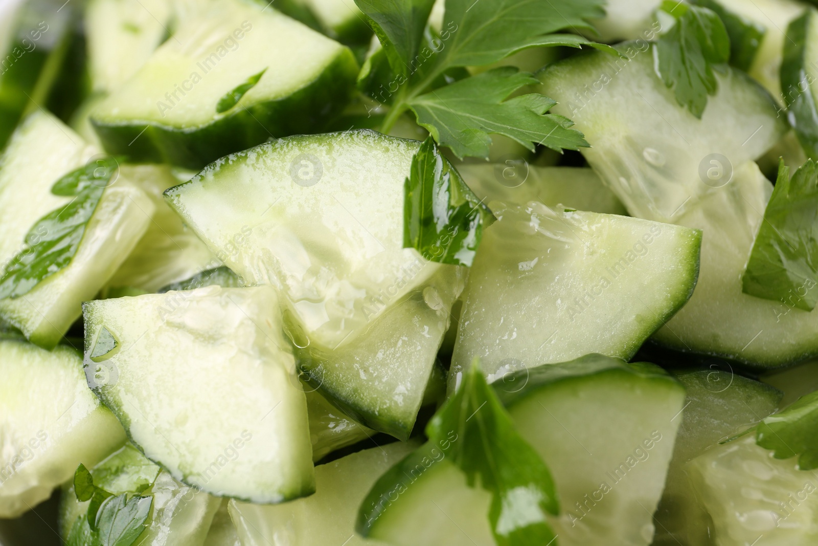 Photo of Delicious cucumber salad as background, closeup view