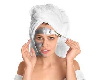 Photo of Beautiful woman applying silver mask on her face against white background