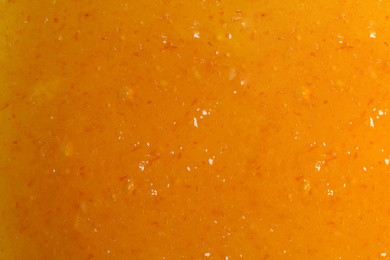 Sweet apricot jam as background, closeup view