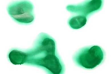 Green spray paint spots on white background