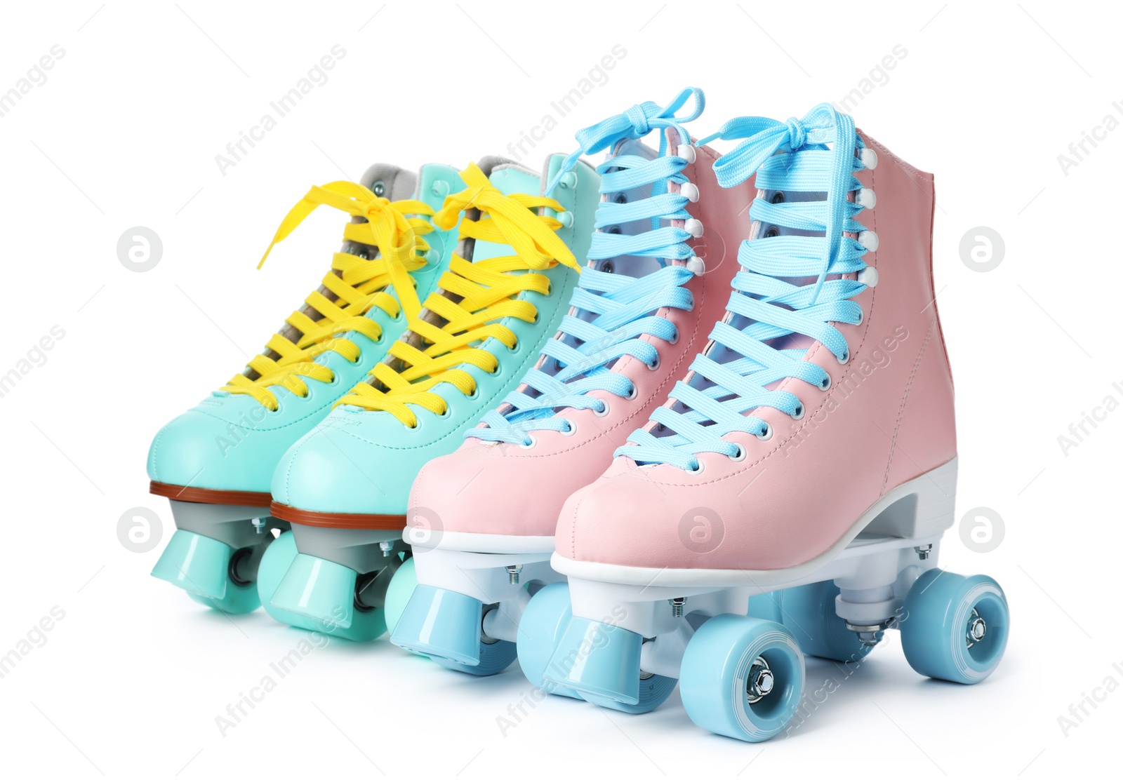 Photo of Pairs of bright stylish roller skates on white background