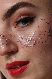 Photo of Beautiful woman with glitter freckles, closeup view
