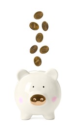 Image of Cents falling into piggy bank on white background