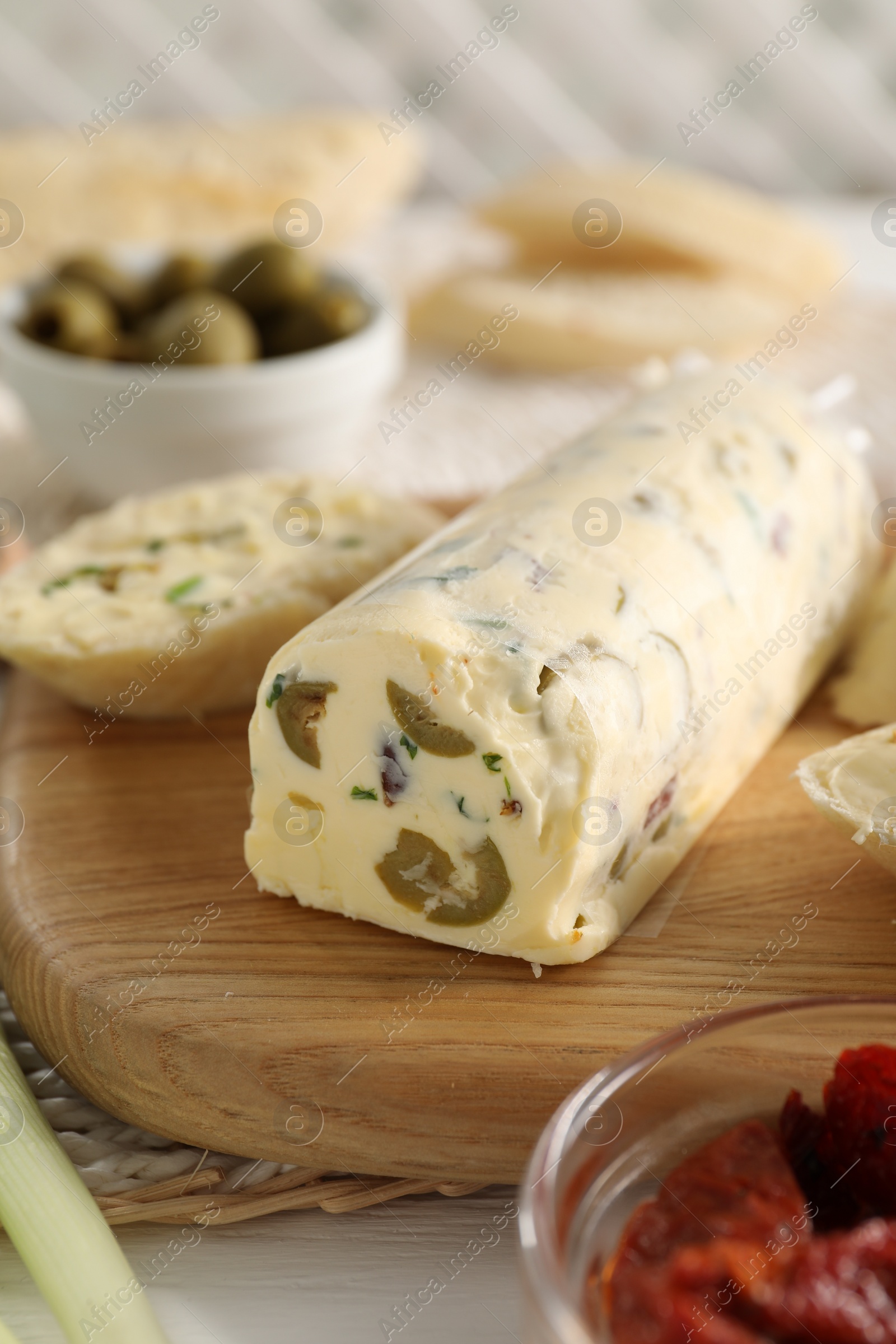 Photo of Tasty butter with olives and green onion on table, closeup