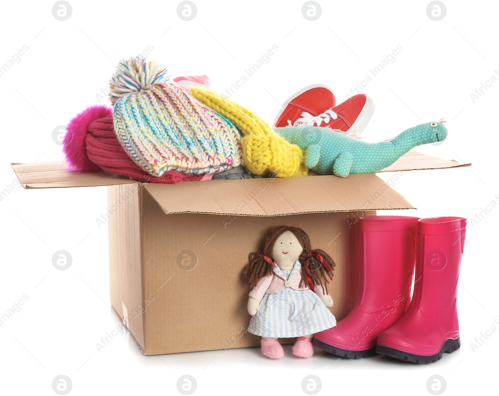 Photo of Donation box, shoes, clothes and toys on white background