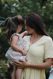 Mother with her cute daughter spending time together outdoors