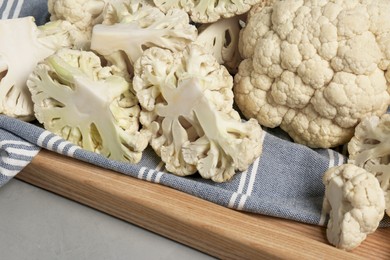 Photo of Fresh raw cauliflower on light grey table, closeup