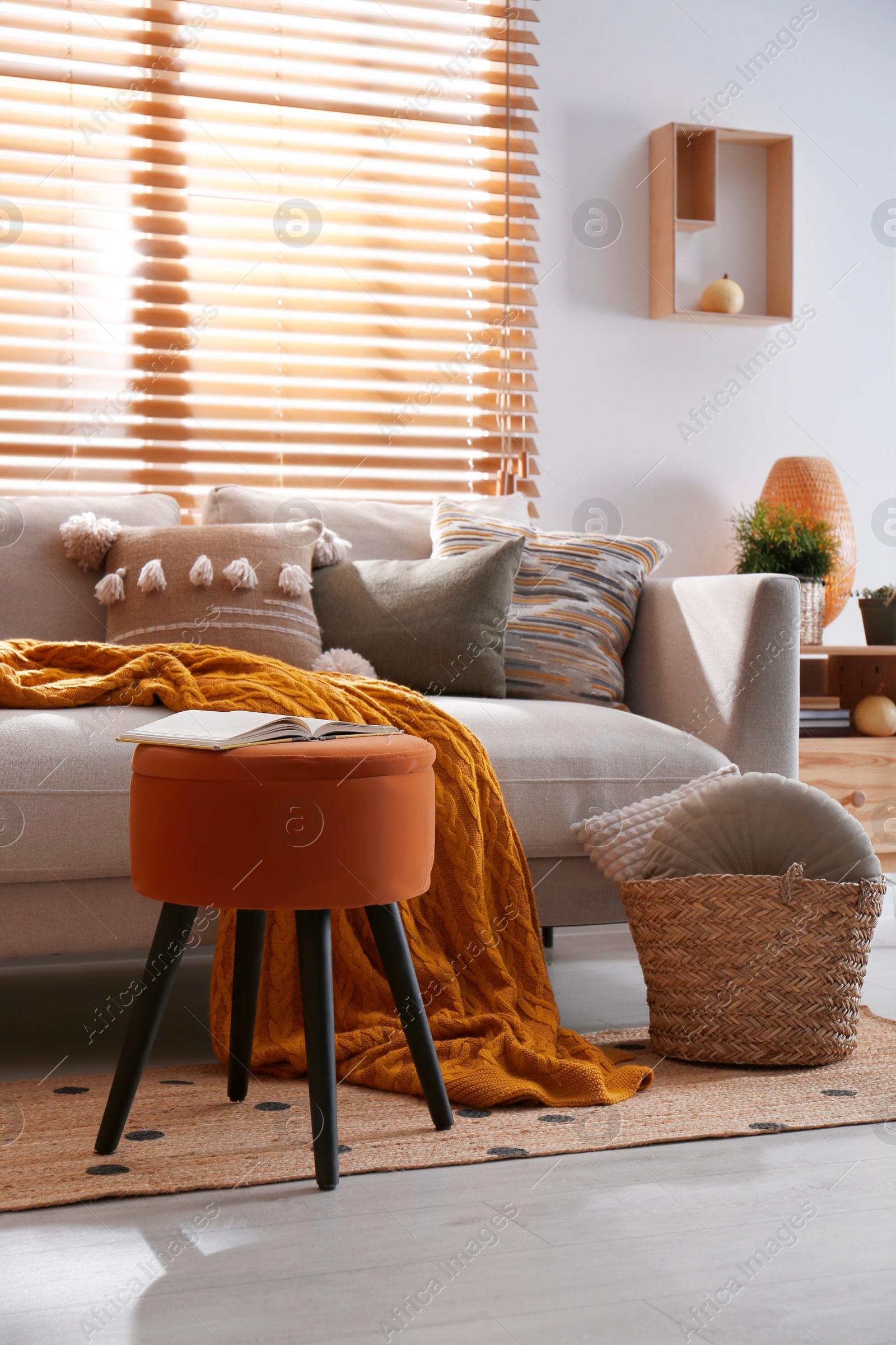 Photo of Stylish living room interior with comfortable sofa and ottoman