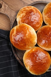 Freshly baked soda water scones on wooden table, top view