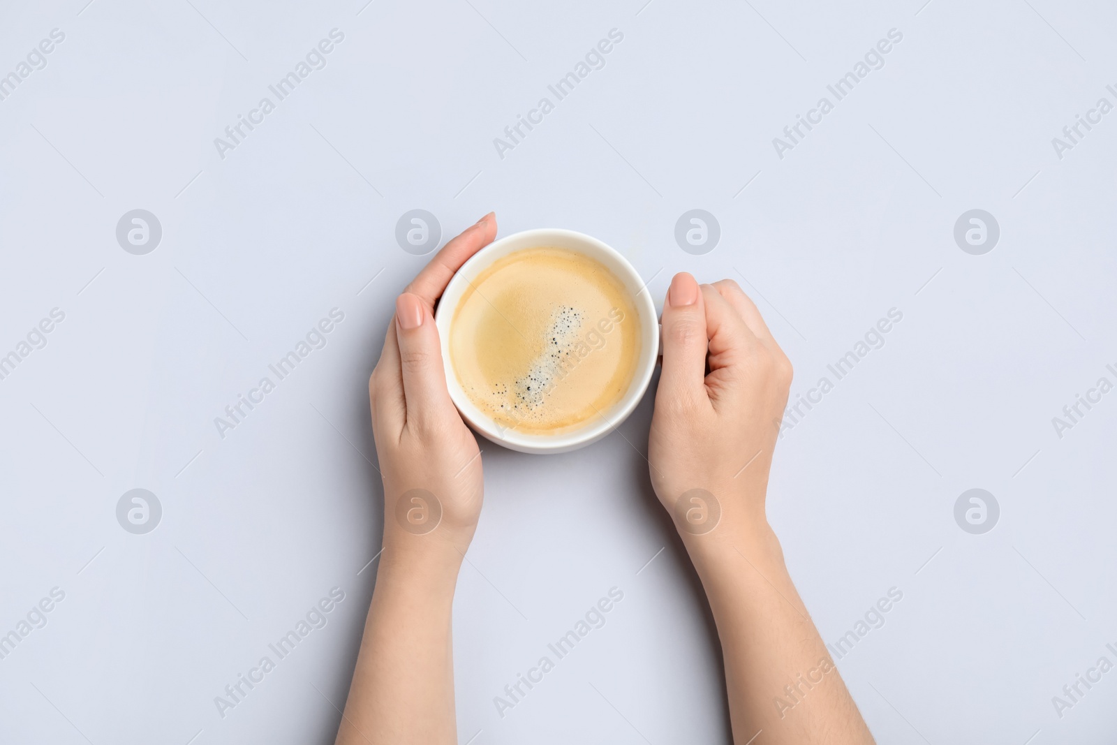 Photo of Woman with cup of coffee on white background, top view