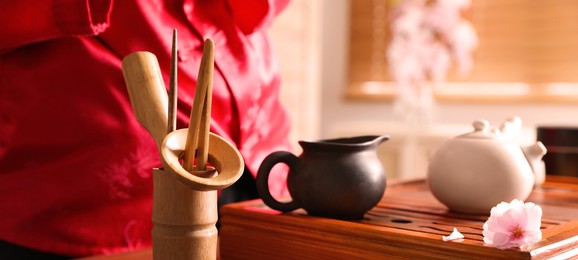 Image of Traditional tea ceremony. Master near tools and tray, closeup