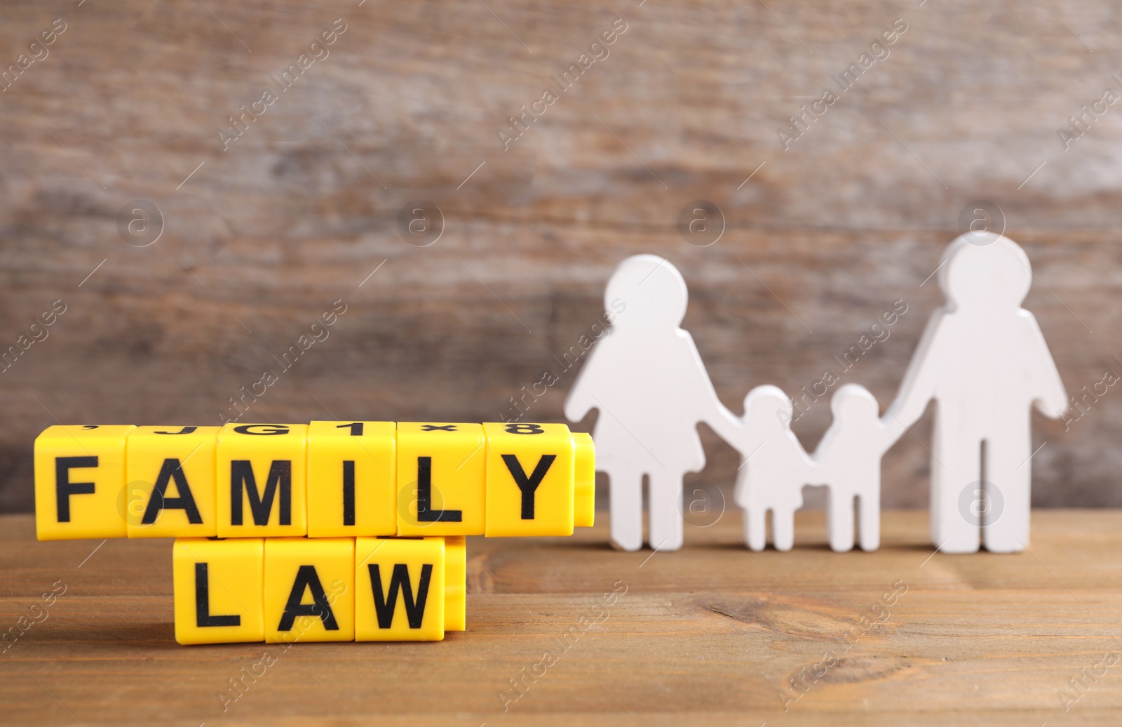 Image of Cubes with letters and family figure on wooden table. Family law concept