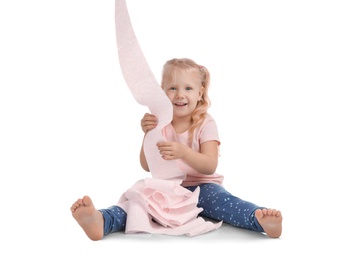 Photo of Cute little girl playing with toilet paper on white background
