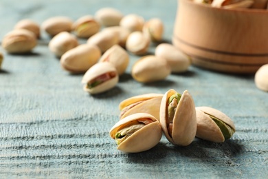 Organic pistachio nuts on wooden table, closeup