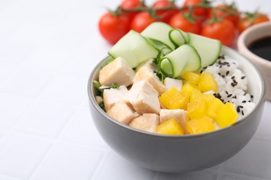 Delicious poke bowl with meat, rice and vegetables on white table, closeup. Space for text