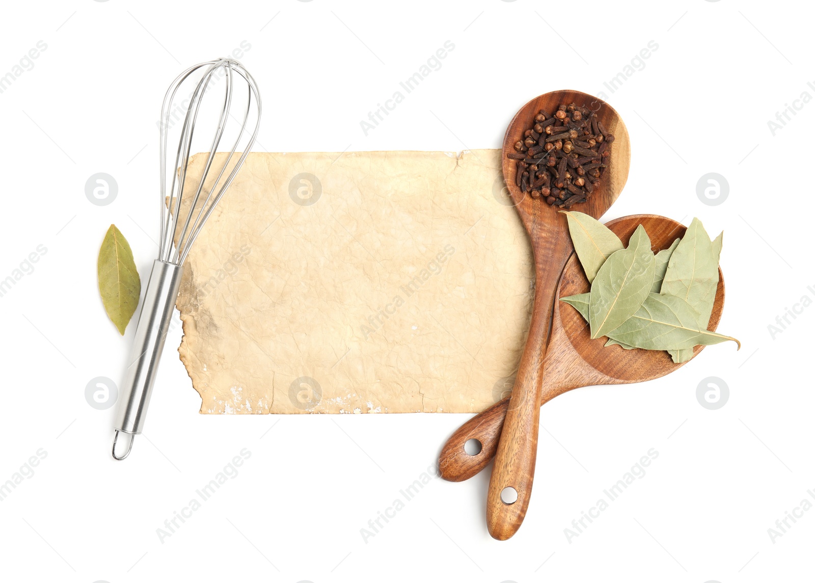 Photo of Old cookbook page, spices and kitchen utensils on white background, top view. Space for text