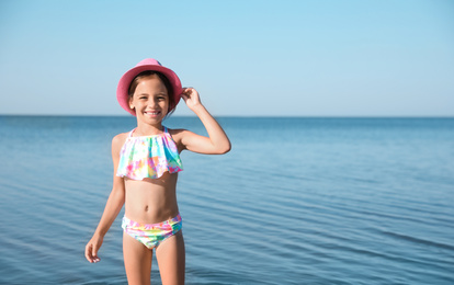 Photo of Cute little child on sunny day. Beach holiday