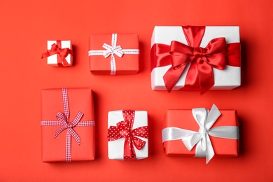 Photo of Flat lay composition with beautiful gift boxes on color background