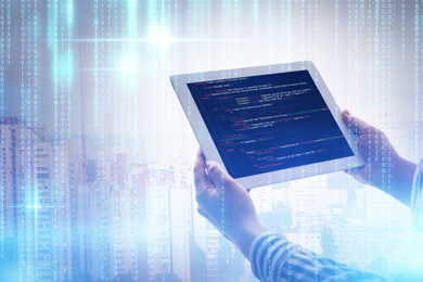 Image of Multiple exposure of female programmer with tablet, digital binary code and cityscape, closeup 