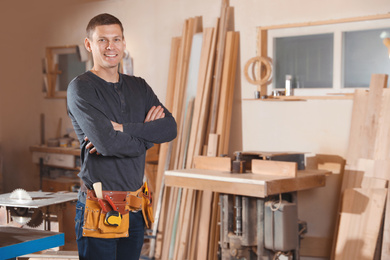 Professional carpenter with set of tools in workshop