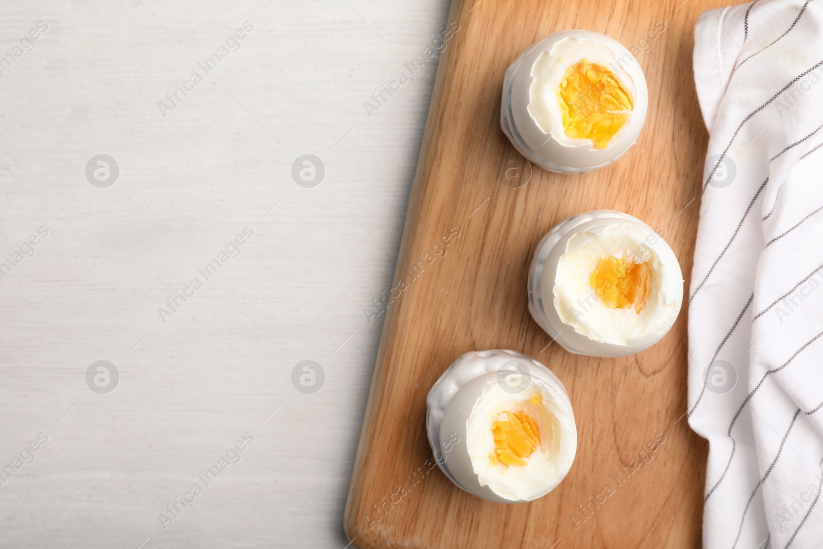 Photo of Flat lay composition with boiled eggs and space for text on wooden background