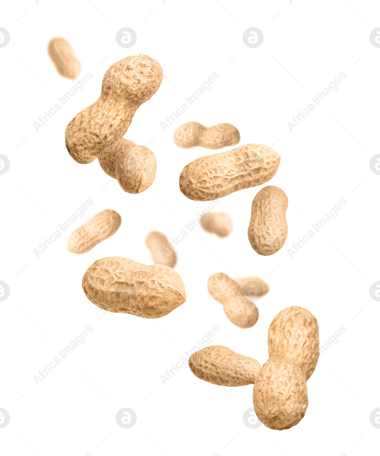 Image of Unpeeled peanuts in air on white background