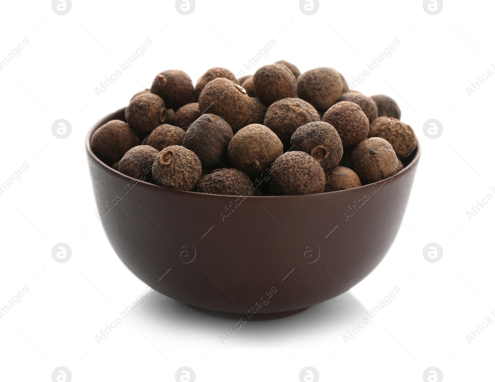 Photo of Bowl with allspice pepper grains on white background