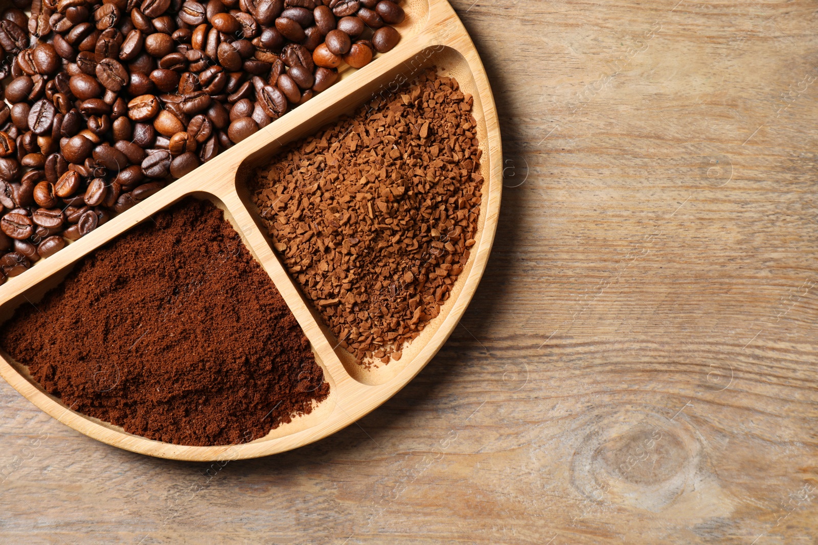 Photo of Instant, ground coffee and roasted beans on wooden table, top view. Space for text