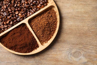 Photo of Instant, ground coffee and roasted beans on wooden table, top view. Space for text