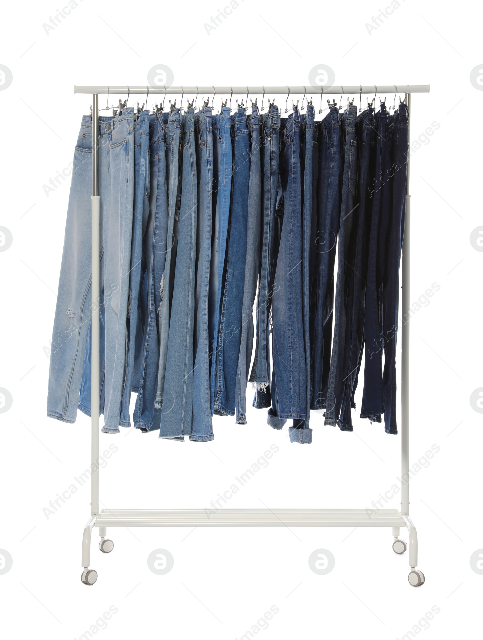 Photo of Rack with different jeans isolated on white