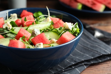 Photo of Delicious salad with watermelon served in bowl, closeup