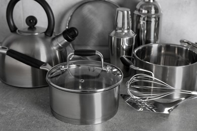 Set of different cooking utensils on grey countertop in kitchen