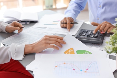 Tax accountants working with documents at table