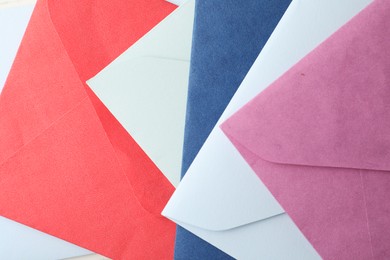 Photo of Colorful paper envelopes as background, top view