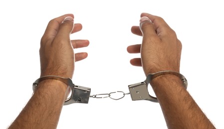 Photo of Man in handcuffs on white background, closeup