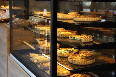 Counter with different tasty pastries in bakery shop