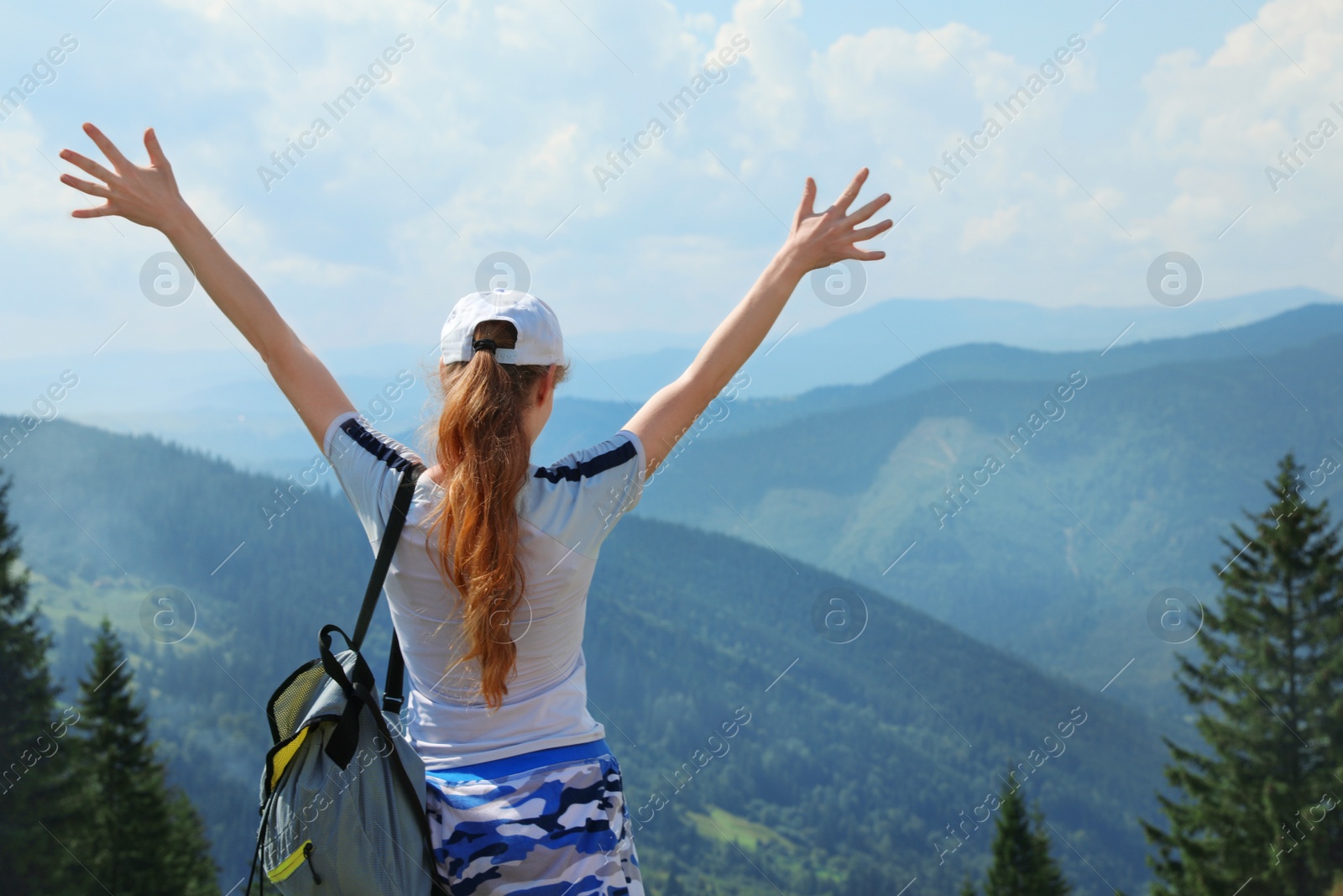 Photo of Woman with backpack in wilderness. Mountain landscape