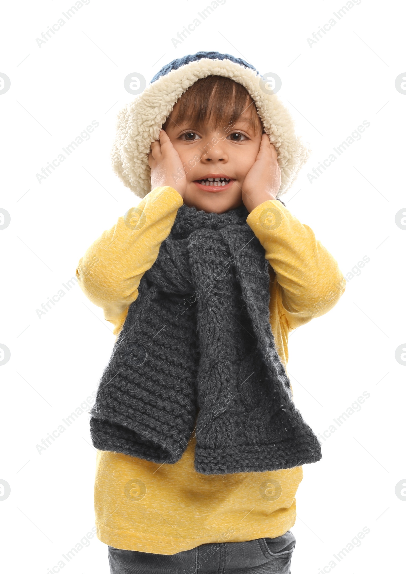 Photo of Cute little boy in warm clothes on white background. Winter vacation